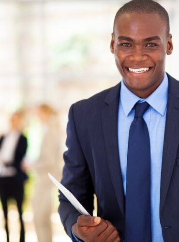 17781738 - handsome african american businessman with tablet computer in office 17781738 - handsome african american businessman with tablet computer in office